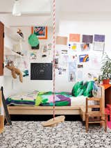 In addition to a swing, Cal's room features Maija &amp; Kristina Isola's Sola bedding for Marimekko.