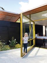 Conceived as a glass wall or window that could swing open rather than a typical door, the resulting glass-and-metal piece is so heavy that it required its own foundation! Thanks to clever engineering by Sand Studios, even seven-year-old Macy can operate the 2,000-pound door.