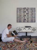 Sitting on the Recycled Blanket Rug by Tejo Remy and Rene VeenHuizen, Chris digs through his records looking for something to play on the new Brionvega RR226 by Achille Castiglioni.