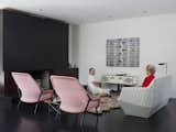 Living Room, End Tables, Rug Floor, Dark Hardwood Floor, Standard Layout Fireplace, Floor Lighting, Chair, Sofa, and Recessed Lighting The living room is home to two Bouroullec Brothers designs: the Facett sofa for Ligne Roset, and the Slow chair for Vitra.  Photo 14 of 15 in How to Design With the Color Pink in Your Home from Designed In-House