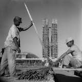 Workers continue constructing Brasilia with the scaffolding-clad towers of the National Congress in the background. Photo by Gervasio Batista.  Search “Continuing-Education.html” from Photos of Brasilia at 1500 Gallery