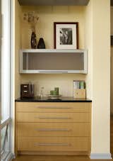 Just inside the patio doors and near the dining table is Braitmayer’s work nook. The top drawer flips out to become a desk; the top cabinet slides straight up to reveal more storage. "It’s very organized," says Sundstrom.