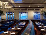 The restaurant occupies three historical buildings formerly used as a working pier. The half nearest the Embarcadero were the ticketing and baggage rooms--now the lobby and bar--and the room nearest the water was the waiting room (now the dining room, shown here). Photo by Eric Laignel.