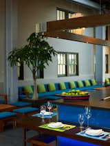 The trick here, Smith says, was connecting the front half of the restaurant with the back half, the dining hall, because an open-air public promenade ran between the two. The solution: closing a section with glass walls (though it's still public space and clearly marked with signs letting walkers know they can stroll right through) and inserting a ceviche bar, made of stained Mahogany, and lounge (both shown here). "Because we had such beautiful historical architecture, we inserted pieces in a stealthy, modernist way," Smith says. Photo by Eric Laignel.