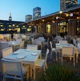 Chairs and tables fills the patio on La Mar's waterfront (which is host to a public pier). Because of fickle San Francisco weather (and quick-to-descend fog), the deck is equipped with roll-down, canvas-and-plastic walls and ample space heaters. Photo by Eric Laignel.