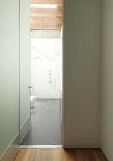 The hallway terminates in the bathroom, flooded in natural light.
