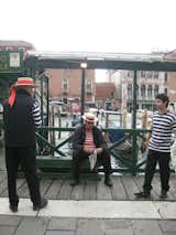 Gondoliers taking a quick minute to relax, catch up, and read the paper.
