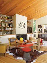In the living room, local artwork and an elegant redwood ceiling watch over a side chair by Warren Platner for Knoll and an Easy Edges side chair by Frank Gehry for Vitra.