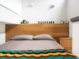 Bedroom and Bed To maximize space, both sides of the bed are outfitted with wall sockets and reading lights.  Search “Herringbone-Blanket.html” from The Manhattan Transformation