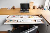 Each of the sliding trays in Pozner’s tidy office desk serves a different function.