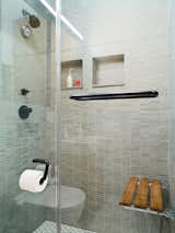 “I got rid of the bathtub because I like the idea of a big shower,” Pozner explains. But to achieve a comparable effect, he installed a teak bench from Waterworks on the rear shower wall. “One of the things I like about a bath is that you can soak. Here I can sit and have the water pound on me—it’s a hybrid shower and bath.”