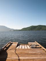 Outdoor, Wood Patio, Porch, Deck, and Trees Down on the cedar dock, the view of nearby Bowen Island generates a dramatic foreground view, while the British Columbia mainland in the distance appears to be a world away.  Search “cedar” from When Living on the Edge is Super Comfortable