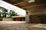 Another view of the central courtyard with the waiting room in the distance. The architects chose to leave their materials—Cor-Ten steel, oak, concrete and stone—solid and untreated, allowing for the natural process of aging to be symbolic of the cycle of life.