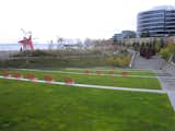 Under protection of the cantilevered roof of the PACCAR Pavilion, it was again the red chairs on the stepped, outdoor amphitheater—as well as Calder's sculpture that matched—that caught my attention. From the distance, Serra's sculpture appears much smaller.  Photo 11 of 12 in Olympic Sculpture Park by Miyoko Ohtake