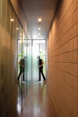 Keener demonstrates how the translucent glass doors in the hallway pivot to create larger private spaces, like an expanded bathroom.