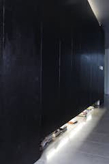 The secret to keeping their minimalist interiors spare? Lots of hidden storage in the hallway, where they stash their books, their clothes, their tools, and their climbing gear.