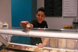 Daniel offers a sample of Bourbon flavor ice cream, on an eco-friendly stainless-steel testing spoon.  Photo 8 of 10 in L.A. Creamery by Erika Heet
