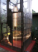 A small door lets cooks and hungry interns into the Cor-Ten steel and corrugated polycarbonate tube.