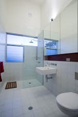 The architect continued the open-plan feeling into one of two full baths (there is another half bath); on the other side of the shower wall is the courtyard’s outdoor shower.