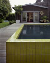 The wall that wraps around the sunken pool was completed—like the seeded concrete pathway—with painstaking precision. The tiles were custom designed with Mission Tile West to hit a pea-green hue and sized specifically to top the narrow walls.  Photo 7 of 10 in Master Stroke