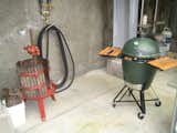 I couldn't resist this juxtaposition of the space-age Big Green Egg cooker and the very old-school wine press.