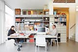 In the work space, custom shelving houses crafting materials (Blans is a keen needle woman) and objects, including toys from Blans's mother's childhood.  Photo 5 of 14 in This Home Takes Recycling to the Next Level