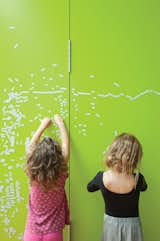 The couple initially painted partition walls between the children's room and their own with black metallic paint creating both a writing surface for the children and a magnetic bulletin board for notes. However, "the black looked too oppressive," Astrakhan says. So they applied several coats of lively lime green paint to brighten up that section of the house.