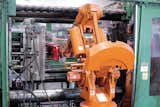 After the rPET mixture is heated and transformed via injection molding into a chair, a robotic arm removes it from the specially designed mold.