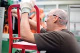 A worker smoothes any imperfections before manually installing the H-brace.  Search “Emecos-111-Navy-Chair.html” from Emeco’s 111 Navy Chair