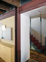 The exposed steel beams delineate access areas from the rooms. The staircase system and fireplaces were fabricated by Wesley Martel.  Photo 9 of 28 in Family Home Renovation in Brooklyn