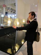 Nigro demonstrates how his Stripes pendant lamps mesh together to form a "composition of intersections."