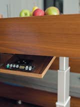 The table's hydraulic controls and hidden drawers.