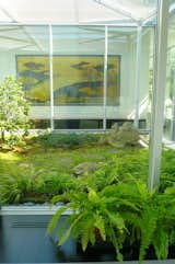 Armstrong designed this mossy, zen courtyard garden to mark the division between the public area of the house (the loft-like living room) and his "private inner sanctum": the master bedroom and his-and-her bathrooms. The plantings pick up on the golden hues of the carefully sited 19th century Japanese screen.