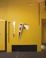 A jumble of windows framed into the bright yellow oriented strand board (OSB) wall looks out from Ionescu’s room onto the common kitchen area. Although the team worked hard to create privacy, each room has some kind of portal or opening that connects it back to the larger loft space.