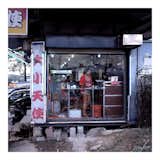 "There are two types of stores: mom and pop shops that are family run and like normal shops, and then the Betel Nut girls shops with the neon signs and glass window that really put the girl on display."  Photo 2 of 13 in Magda Biernat's Betel Nut Girls by Aaron Britt