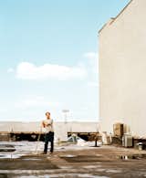Cinematographer Wilmot Kidd sweeps the roof of the Red Hook industrial building that contains his home.