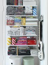 To keep her open storage neat, Susanna stacks and organizes her books and DVDs by size and by color.