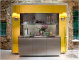 Bright and cheery, the Primary Kitchen combines the stainless steel of the Duality Kitchen and the color of the Library Kitchen.  Photo 5 of 7 in Philippe Starck's Library Kitchen