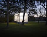 Completed in 2009, the studio shines in the night among the trees. Weiselberg and Semaan devised a clever foundation system that allowed them to avoid ripping up roots. “The floor is a concrete slab on a steel deck that sits on a spider web of steel beams,” Weiselberg says. “There are eight piers per side of the structure, each designed so that if we dug the 12-inch hole and there were roots underneath, we could move it along a certain radius. The base is like a skirt that is just hanging off the building.” So while the floor floats a foot above the ground in the couple’s backyard for now, it could one day easily be picked up and moved elsewhere.