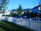 View from side yard. Corner lot, white picket fence, mountain view and streets lined with suburbia.  Photo 3 of 10 in Building the Maxon House: Week 1