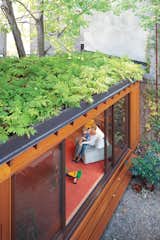 A small, single-story addition to the row house adds a playroom without eating up too much outdoor space. A green roof also helps makes up for lost garden beds, while creating attractive, leafy views from the second and third floors. In summer, when the sliding doors are left wide open, indoor and outdoor spaces blend together.