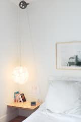 For a simple, low-cost bedside reading light with a dash of industrial style, Bernier ran a standard-issue cord set through a vintage clothesline pulley, which he picked up at a flea market, on Thibault’s side of the bed. "If she ever wants it to be higher, she can easily adjust it," he says.