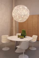 A Fil de Fer pendant light fixture by Catellani and Smith hangs over a S-Table in matte white resin by MDF Italia, surrounded by glossy Flow chairs. Along the wall is the Centopercento closet system by Tisettanta.

Don't miss a word of Dwell! Download our  FREE app from iTunes, friend us on Facebook, or follow us on Twitter!