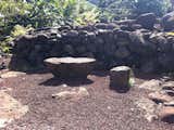 Two large sculptural lava rocks in the form of a table and chair would be great in the open area in our yard currently half-filled with the black rocks Ellwood often used as a hardscape border element.