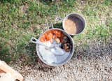 Food is served in traditional camping cookware.
