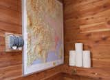 A peek inside the bathroom, where a raised topographic map doubles as reading material and travel inspiration.
