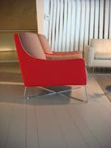 The Shanghai armchair by Italsofa boasts cherry-red fabric and seemingly delicate metal base.