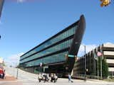 The street-facing-facade is entirely glass and the opposite is essentially a gently-curved hull. Upon approach, you tread over gang-plank-like walkway that spans a moat. Yes. A moat.  Photo 6 of 18 in The Architecture of High Point by Diana Budds