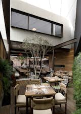The first-floor space between the two second-floor structures creates one of two dining patio. "The chef wanted a fresh space that would basically be like an open market," Ortiz de Zevallos says.  Photo 5 of 10 in Lima's El Mercado Restaurant by Miyoko Ohtake