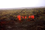 While driving through a field of moss-covered volcanic rock, I spotted a group of cave explorers in orange, reminding me of a team of astronauts walking on another planet.